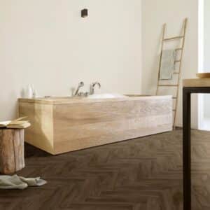Kefi Sheet Vinyl – Walnut Herringbone in a bathroom